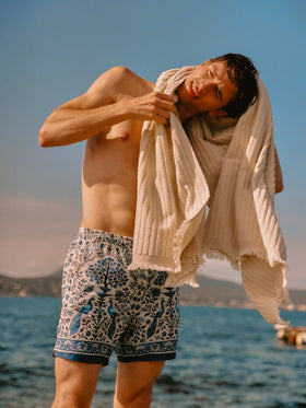 Gustavia white swim shorts with contrasting peacock print